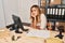 Young blonde woman ecommerce business worker boring sitting on the table at office