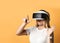 Young blonde woman is excited with virtual reality she is using wearing vr glasses. Woman in cyber space and virtual gaming