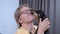 Young blonde woman with glasses hugs cute dachshund dog. Animal licks face of owner expressing its love. Single strong