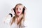 Young blonde woman hearing music with earphones