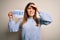 Young blonde woman holding brexit banner from political referendum over isolated background stressed with hand on head, shocked