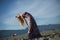 Young blonde woman long hair streching beach