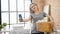 Young blonde woman make selfie by smartphone holding basket with clothes at laundry room