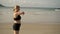 Young blonde woman making sport exercises on a beach