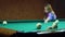 Young blonde woman plays in russian billiards.