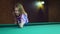 Young blonde woman plays in Russian billiards.