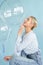 young blonde woman posing in studio with transparent balloons. Concept dreaming