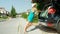 Young blonde woman pushes a suitcase further into the trunk stuffed with luggage