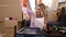 Young blonde woman repairing table using screwdriver at new home