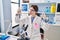 Young blonde woman scientist analysing test tubes at laboratory