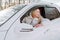 Young blonde woman sit in white car and smile happy. Insurance, safety, rent a car and travel.