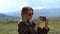 Young blonde woman taking shot on smartphone. Outdoor nature travel concept