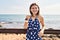 Young blonde woman tourist smiling confident holding ice cream at seaside