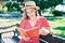 Young blonde woman on vacation reading book sitting on bench at the park