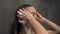 Young blonde woman washing her hair with shampoo in the shower