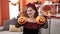 Young blonde woman wearing katrina costume holding halloween pumpkin baskets at home