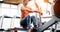 Young blonde woman working on rowing machine