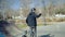 A young bmx rider leaving an extreme park, waving a hand and saying bye to his friends