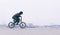 Young BMX rider riding a bike on a minimalist city background. BMX cyclist is going to make a trick