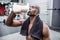 Young Bodybuilder drinking a bottle of water after the training