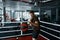 Young boxer trains with punching bag in gym