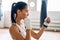 Young boxer woman posing in combat stance in gym