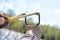 Young Boy Aiming Sling Shot Over Lake