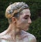 Young boy at the art make-up as golden caesar profile