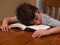 Young boy asleep while reading