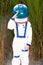 Young boy in an astronaut suit saluting