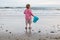 Young Boy on Beach with Blue Pail at Sunset