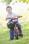 Young boy on bicycle outdoors smiling