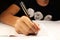 A young boy with black t-shirt writing dictation in english lesson. Elementary school.