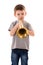 Young boy blowing into a trumpet