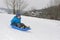 Young boy on blue sled