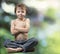 Young boy Buddha on green forest