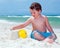 Young boy builds sand castle