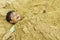 Young Boy Buried in Sand