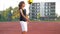 Young boy with caucasian appearance kicks soccer ball outdoors. He has a lot of fun playing football.