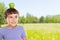Young boy child with an apple fruit on his head outdoors copyspace copy space healthy eating