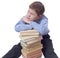Young boy in classic dress sitting with heap of books