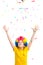 The young boy in clown wig throws colored confetti