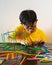 A young boy is constructing colorful plastic sticks. fun with building geometric figures and learning mathematics at home
