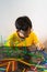 A young boy is constructing colorful plastic sticks with glue gun. fun with building geometric figures and learning mathematics at