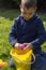 Young Boy Cracks Open an Easter Egg Over a Filled Bucket