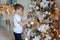 Young boy decorating Christmas tree