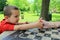 Young boy determined to beat his mom at thumb wrestling