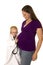 Young boy doctor with stethoscope on pregnant moms belly listen