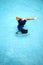 A young boy doing a somersault in the swimming pool