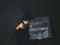 Young boy dressed as a magician is holding happy halloween chalkboard